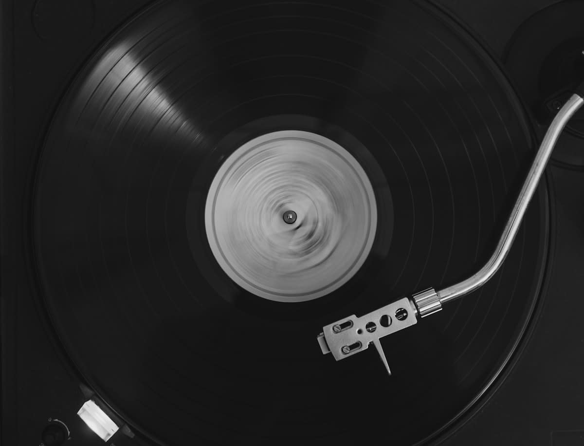 Close up of a vinyl record player needle on a disc