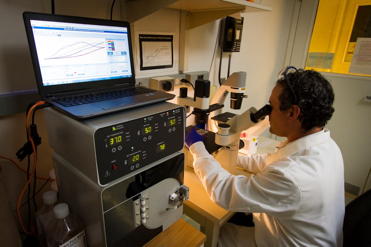 Laboratory technician analyzing DNA sequences on a screen