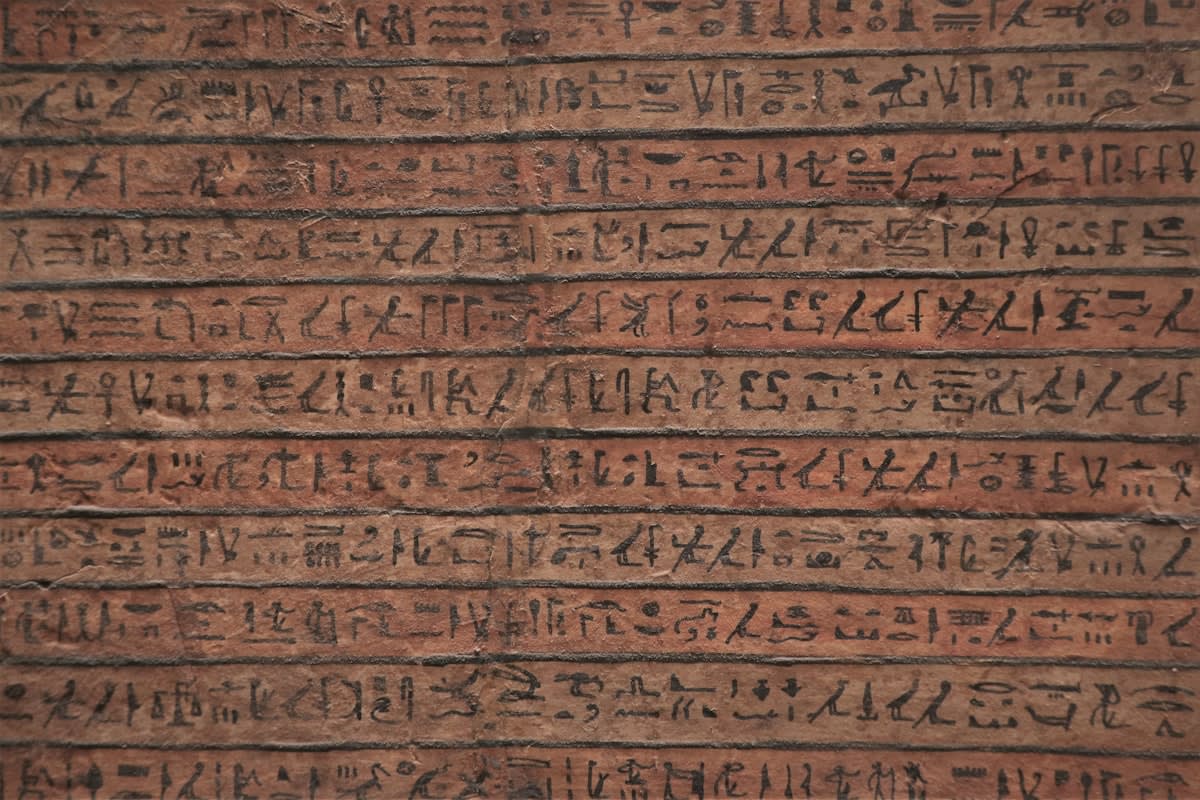 Digital data streams blending into ancient papyrus scrolls