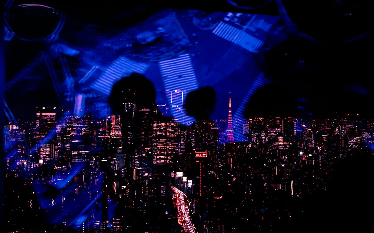 A diverse group of people in a futuristic city looking at holographic displays of their own social data