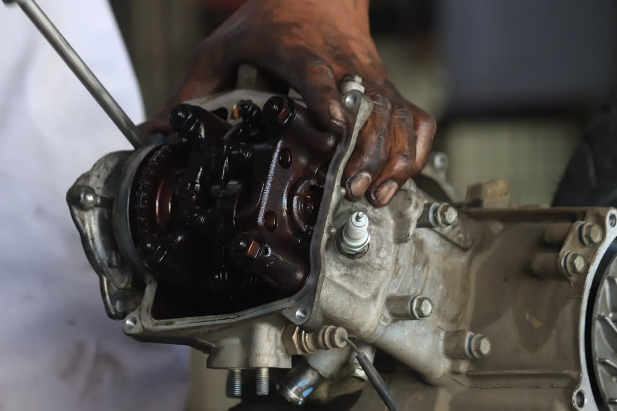 human hand adjusting a mechanical gear