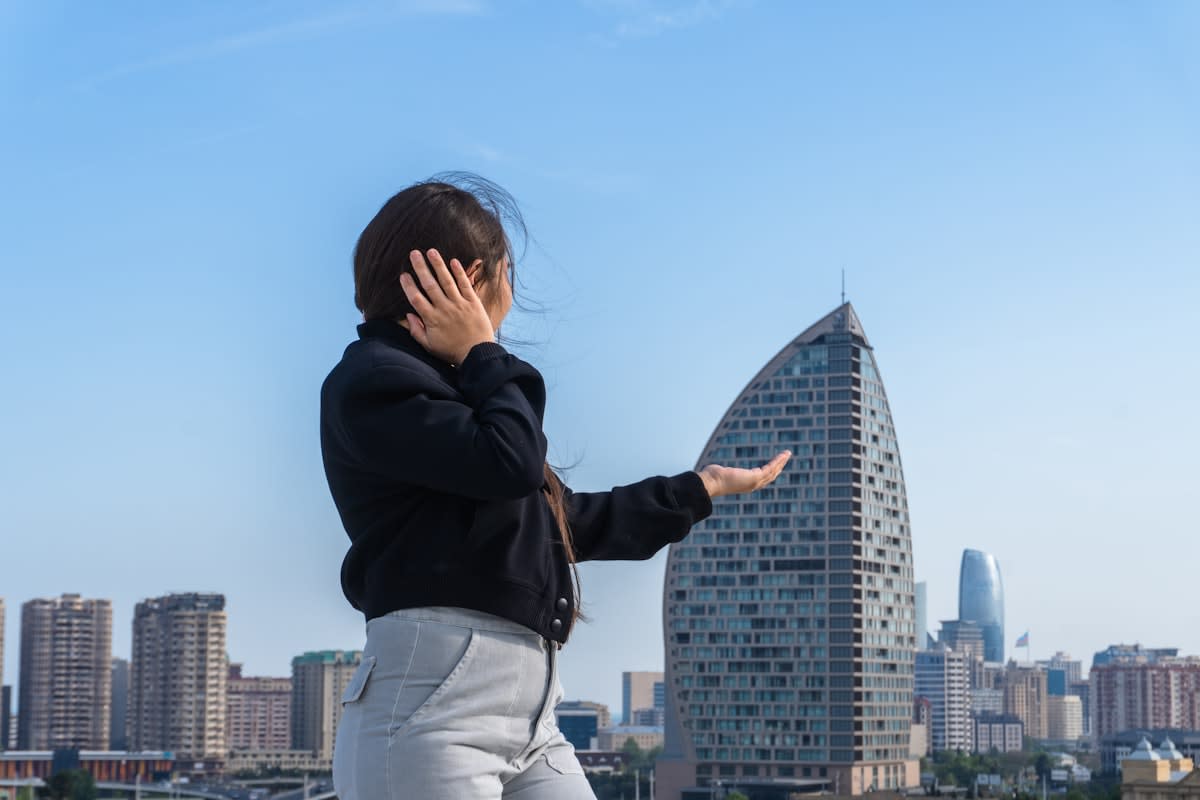 A person practicing mindful breathing in a busy urban environment