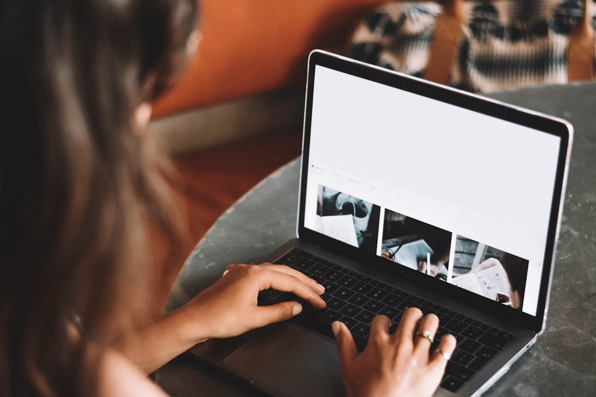 A laptop showing a video call with another person working