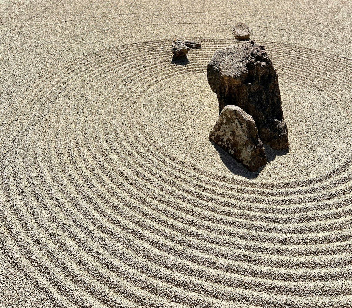 Zen garden with raked sand and a single stone