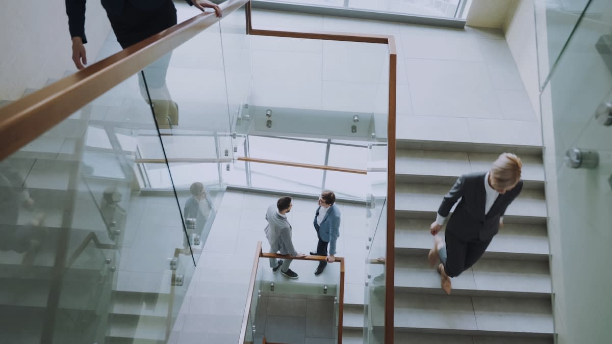 Two professionals shaking hands in a modern architectural setting