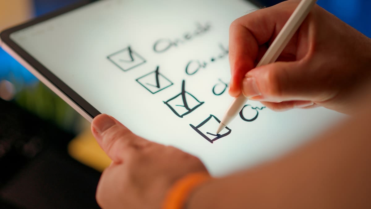 Close up of a digital tablet showing a productivity app with checked off tasks