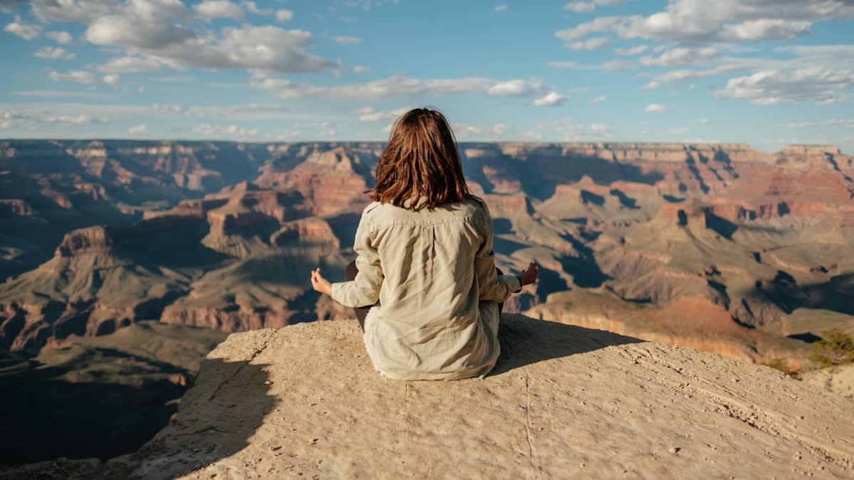 Person meditating in nature