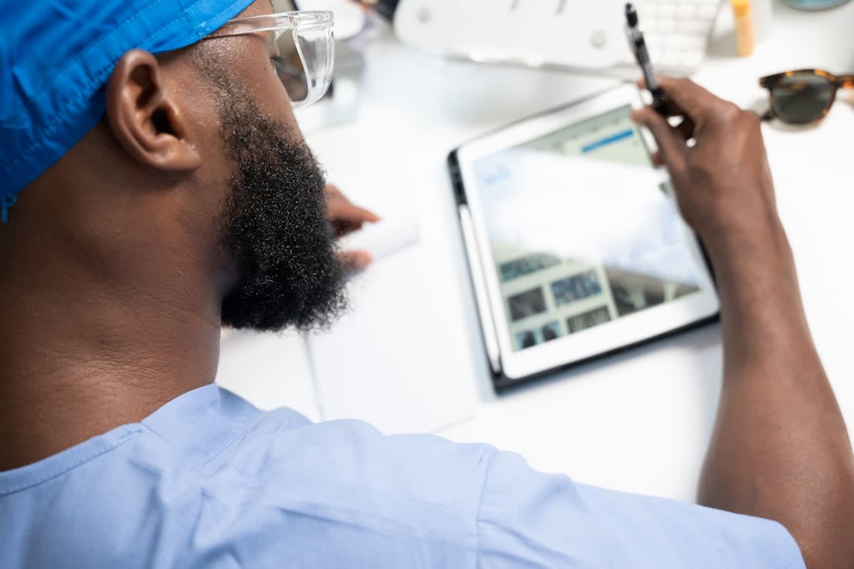 Medical professional analyzing data on a tablet