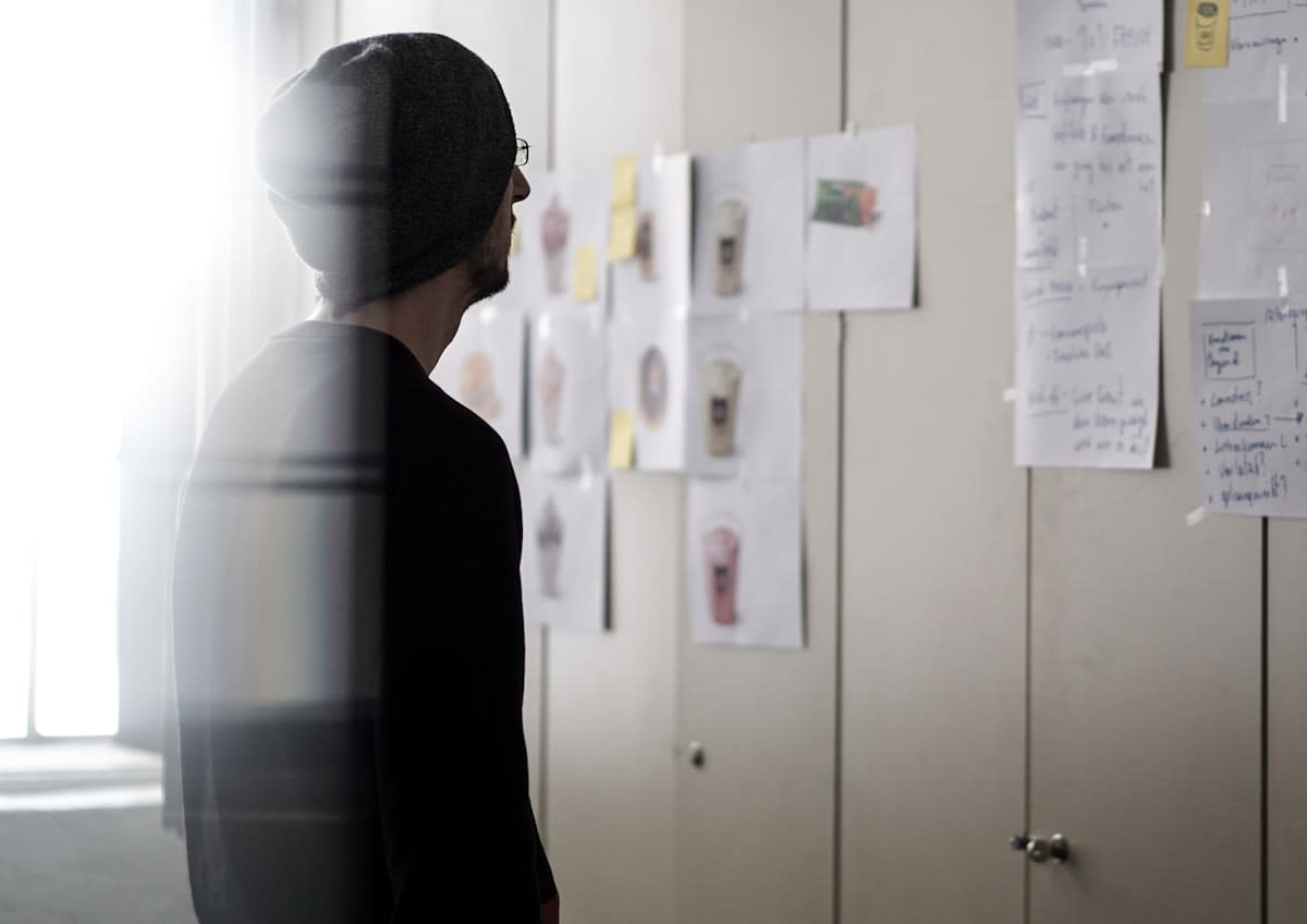 A person looking at a wall of identical options, representing decision fatigue