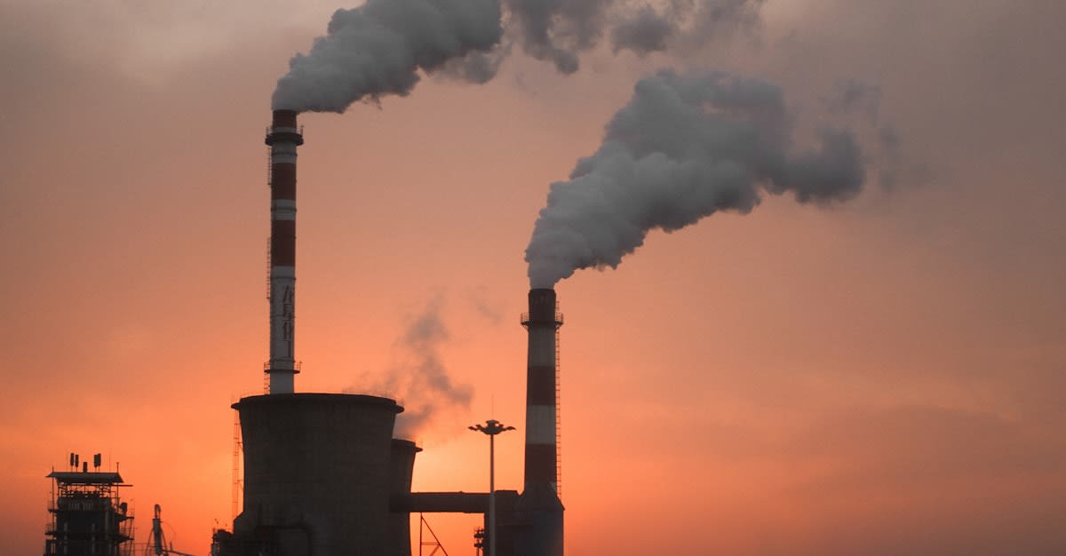 Industrial factory with smog and clear sky contrast