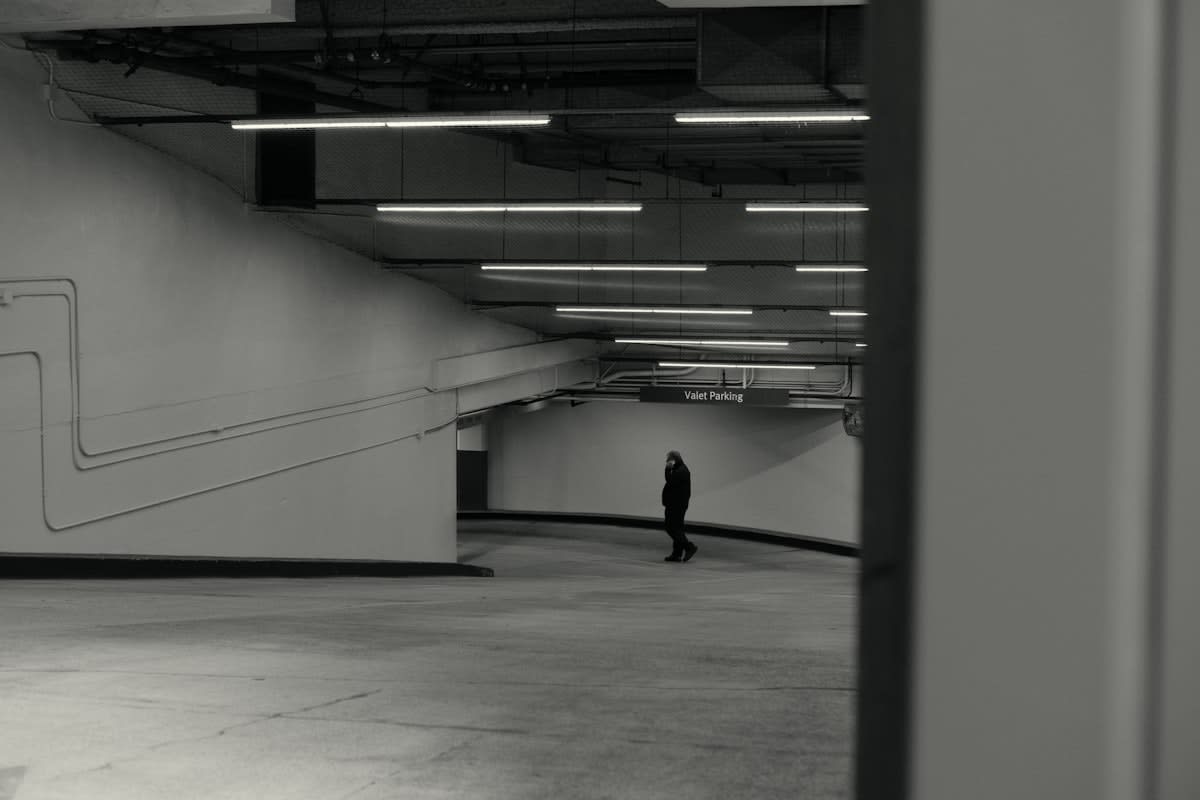 Minimalist architecture showing vast empty space and a single person