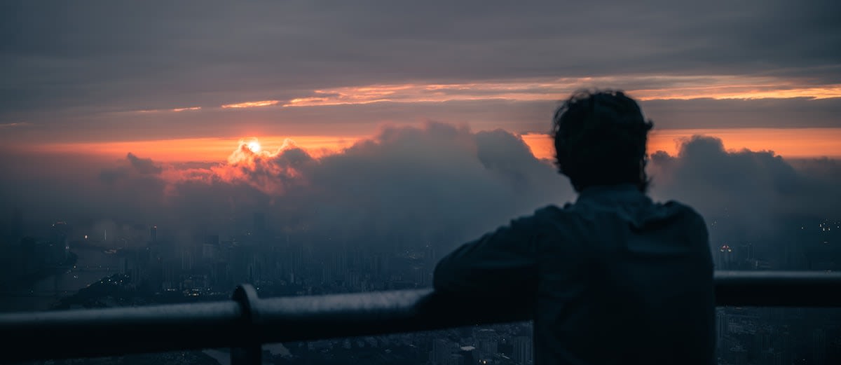 Close up of a person staring into a distant horizon without technology
