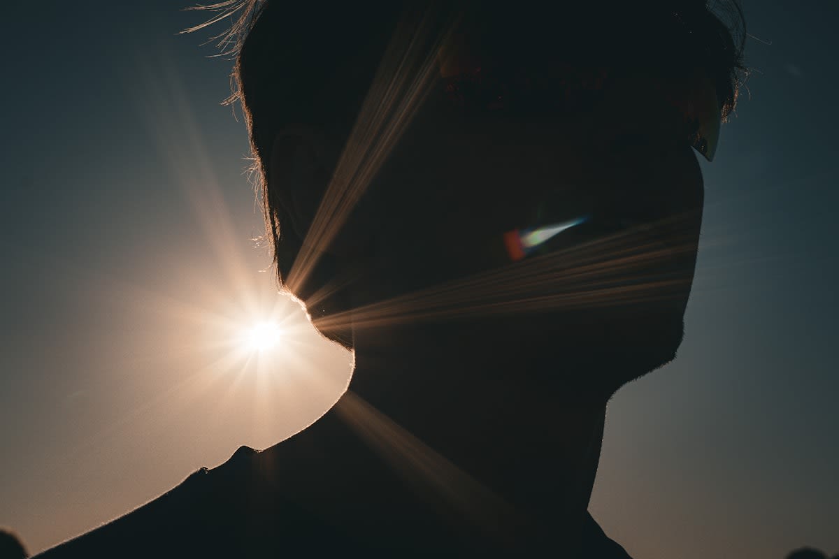 morning sunlight hitting a person's face outdoors