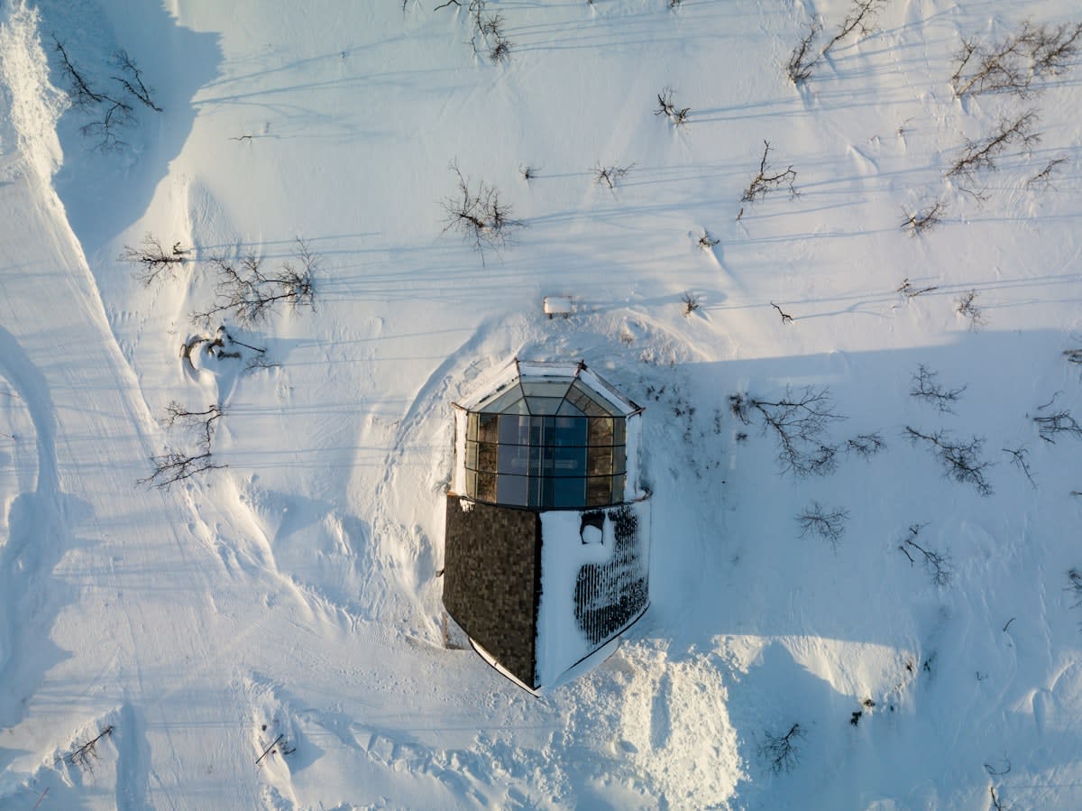 Aerial view of a remote Swedish cabin in a snowy landscape