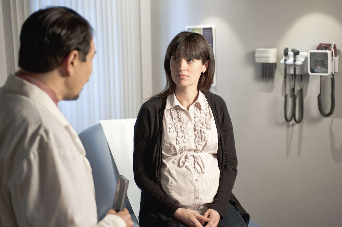 pregnant woman consulting with doctor