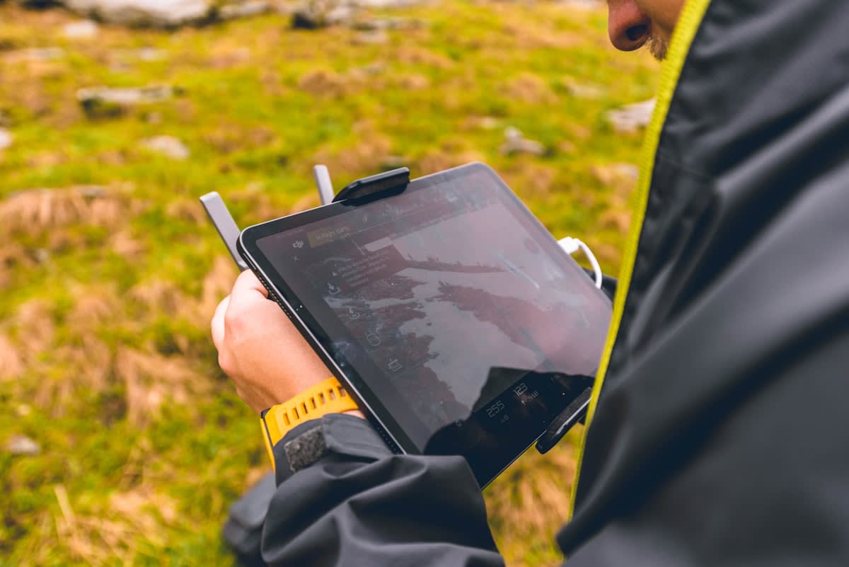 athlete wearing wearable tech and looking at data on a tablet