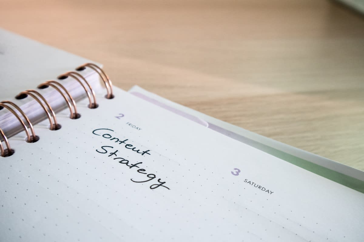 Close up of a professional notebook with detailed strategic notes and cross-outs