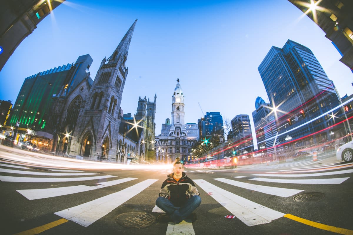 Person meditating in a busy urban environment