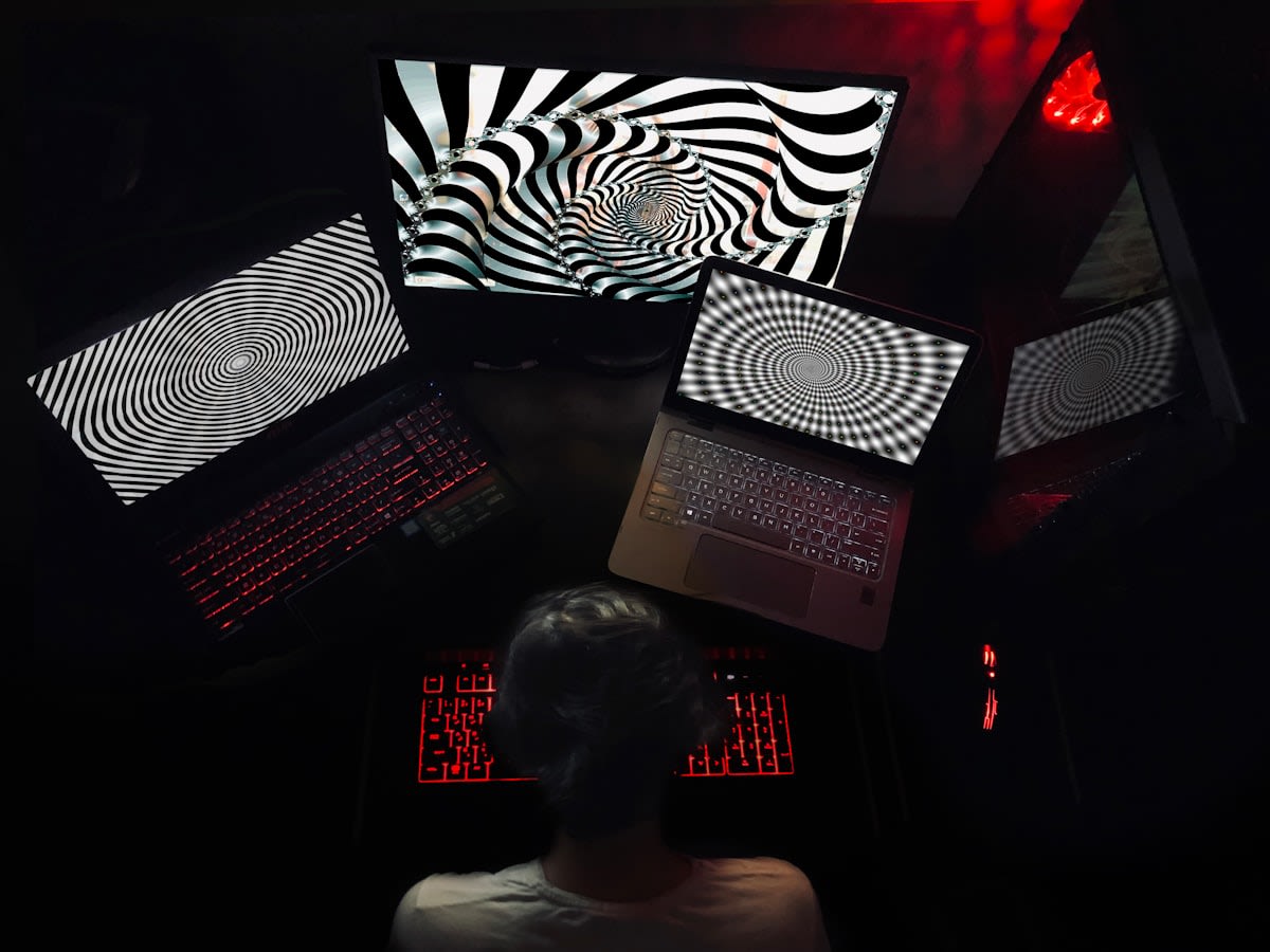 A person looking at multiple screens with diverse data