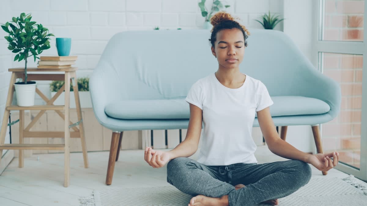Person practicing yoga or meditating in a quiet room