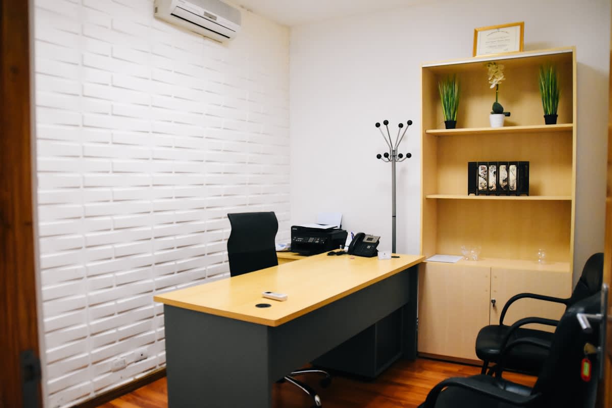 Minimalist corporate office with a single empty chair and a silent phone