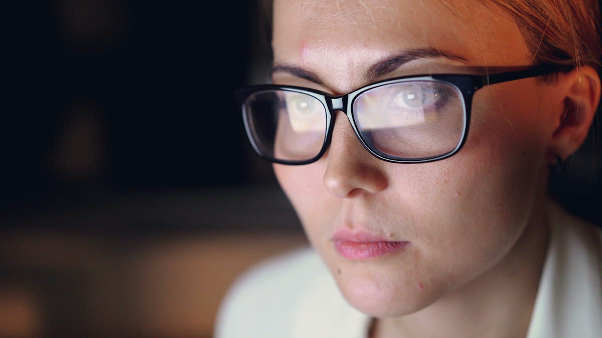 Close up of a professional looking concerned while looking at a computer screen with AI data