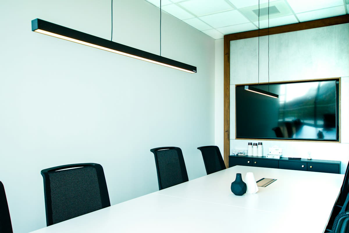 A dark boardroom with a single light