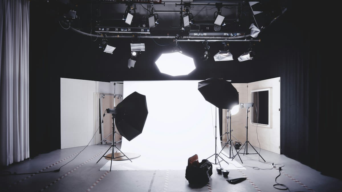 Film camera on a set with lighting equipment