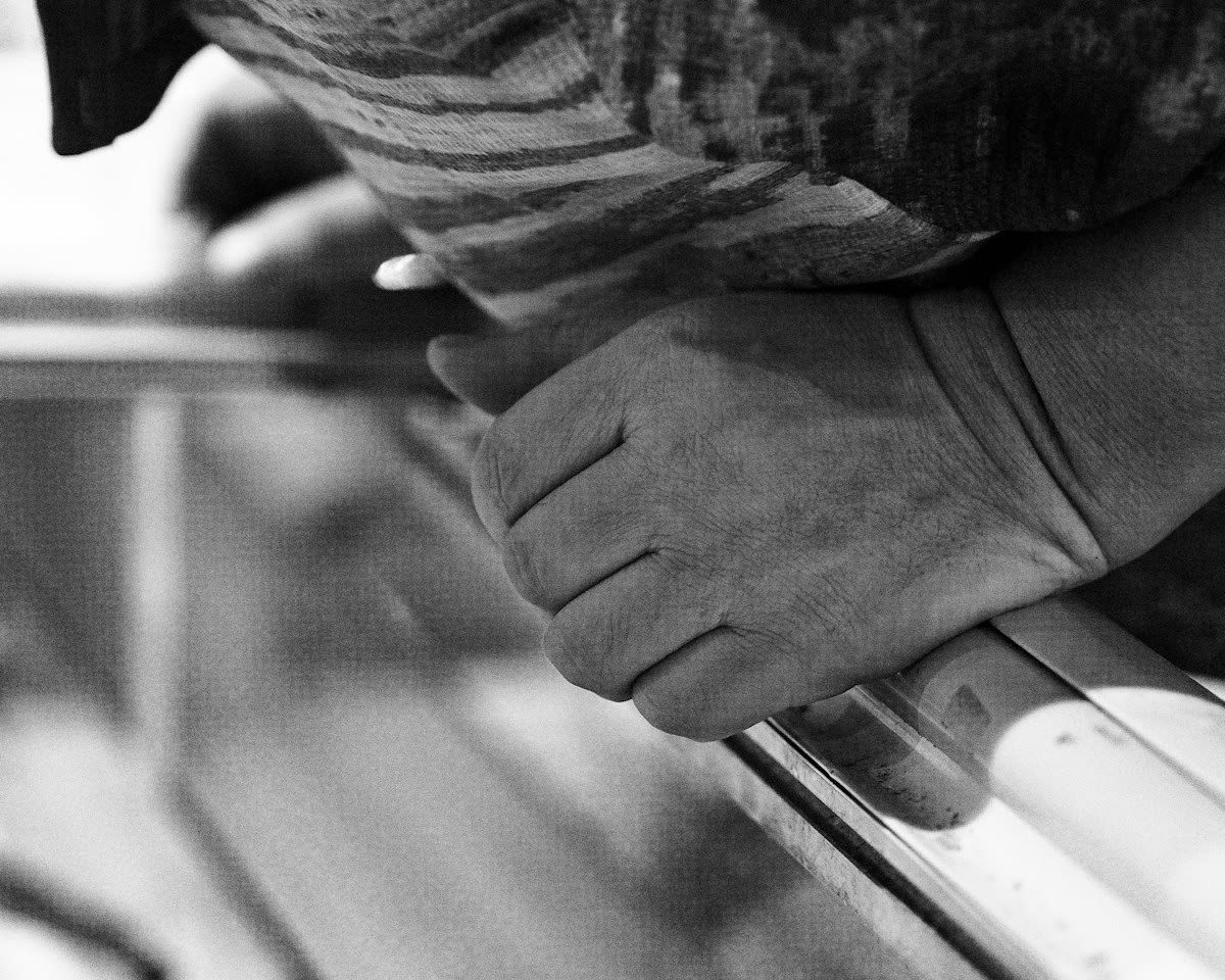 Artist hands covered in ink working on a press
