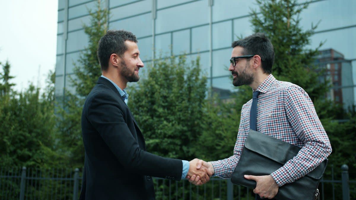 Close up of hands shaking in a business setting