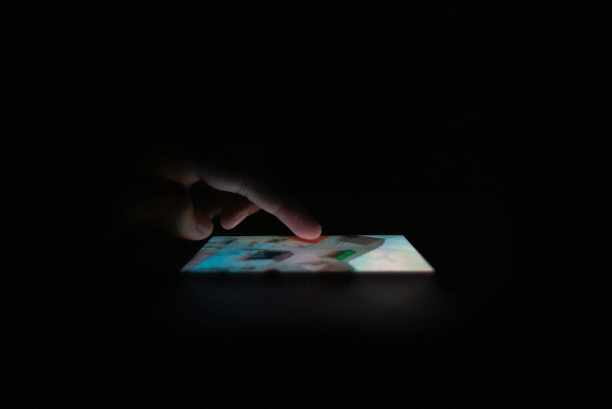 smartphone screen displaying vertical video in a dark room