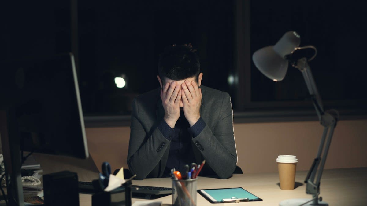 stressed professional in a dark office