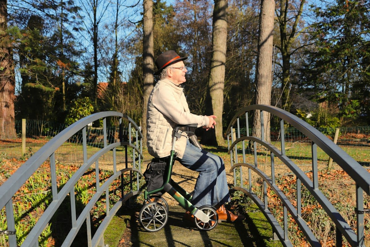 Elderly person balancing on one leg in a park