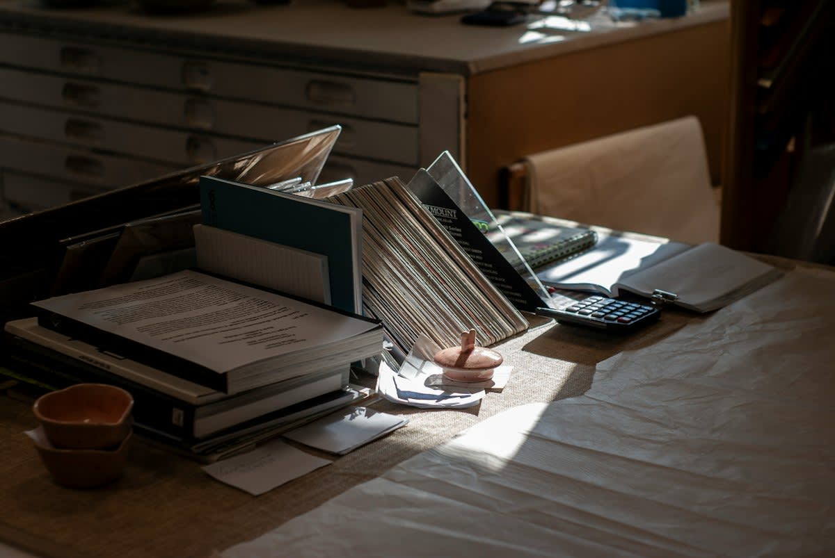 Bureaucratic paperwork stacking up on a modern office desk