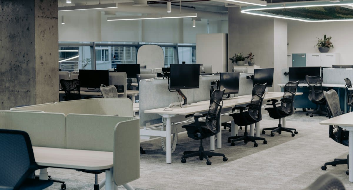 A desolate modern office space with empty chairs