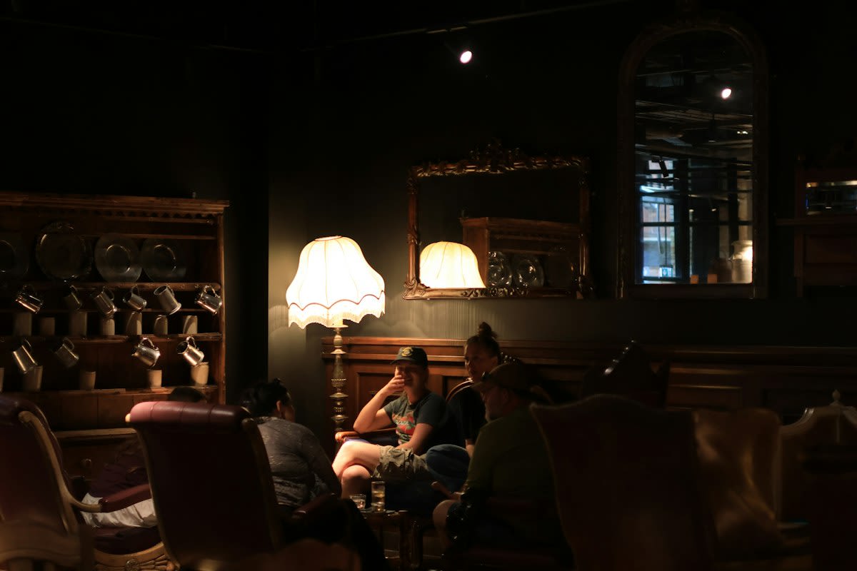 Close up of two people shaking hands in a dim lounge