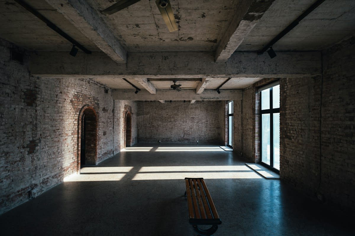 minimalist empty concrete room with harsh lighting