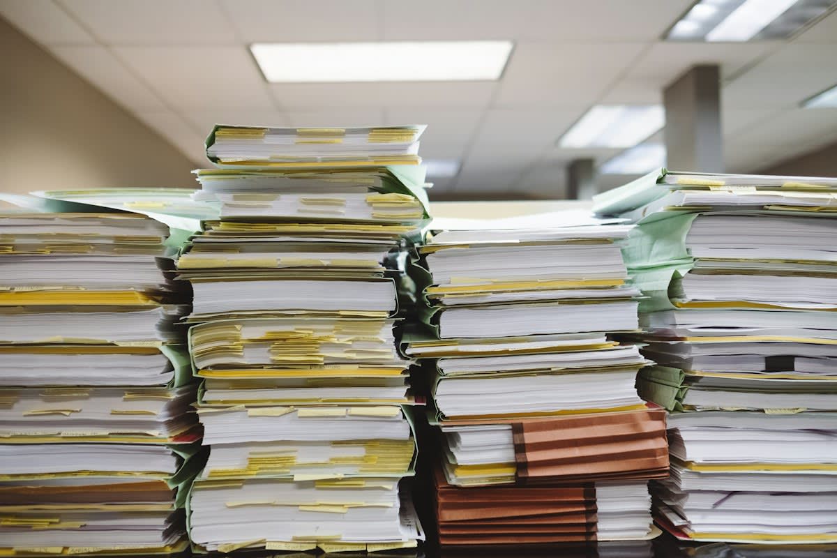 Chaotic office environment with piles of paperwork