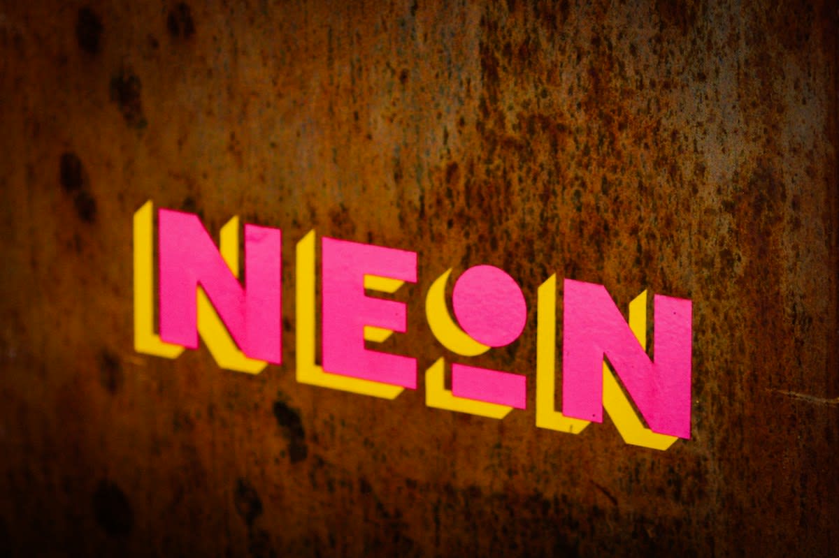 Neon clashing colors, distorted typography, maximalist graphic design