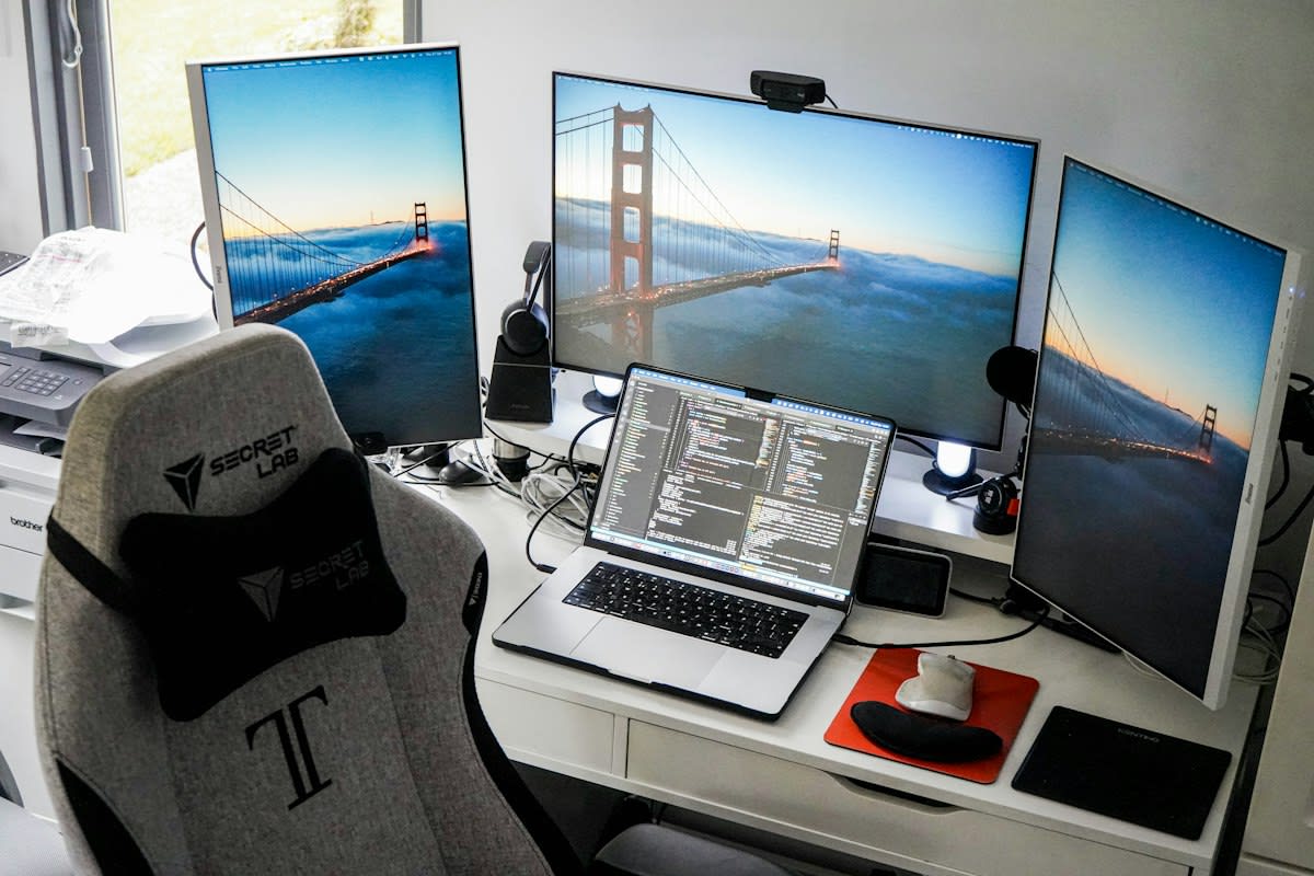 Modern workspace with multiple monitors and code
