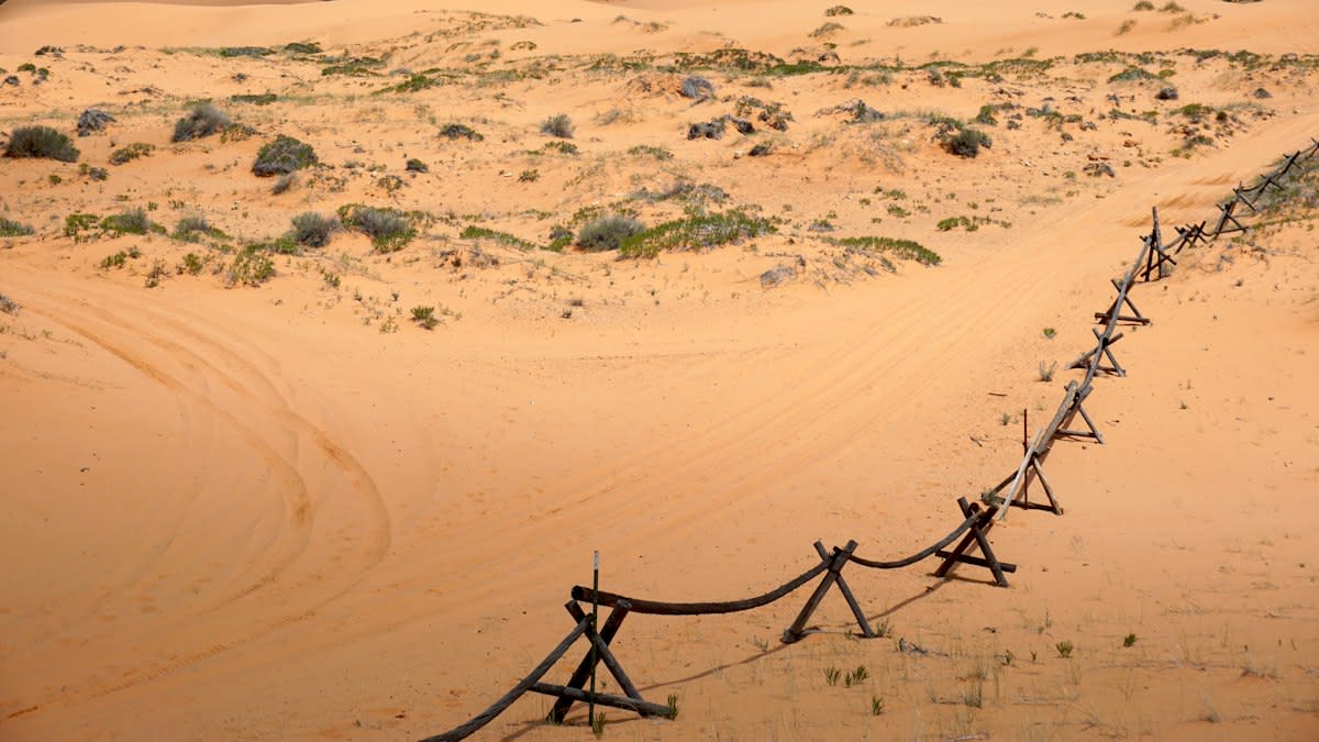 Dry desert landscape with irrigation pipes