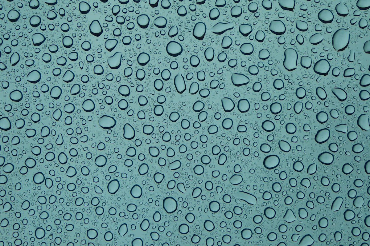 Close up of water droplets on a metallic surface
