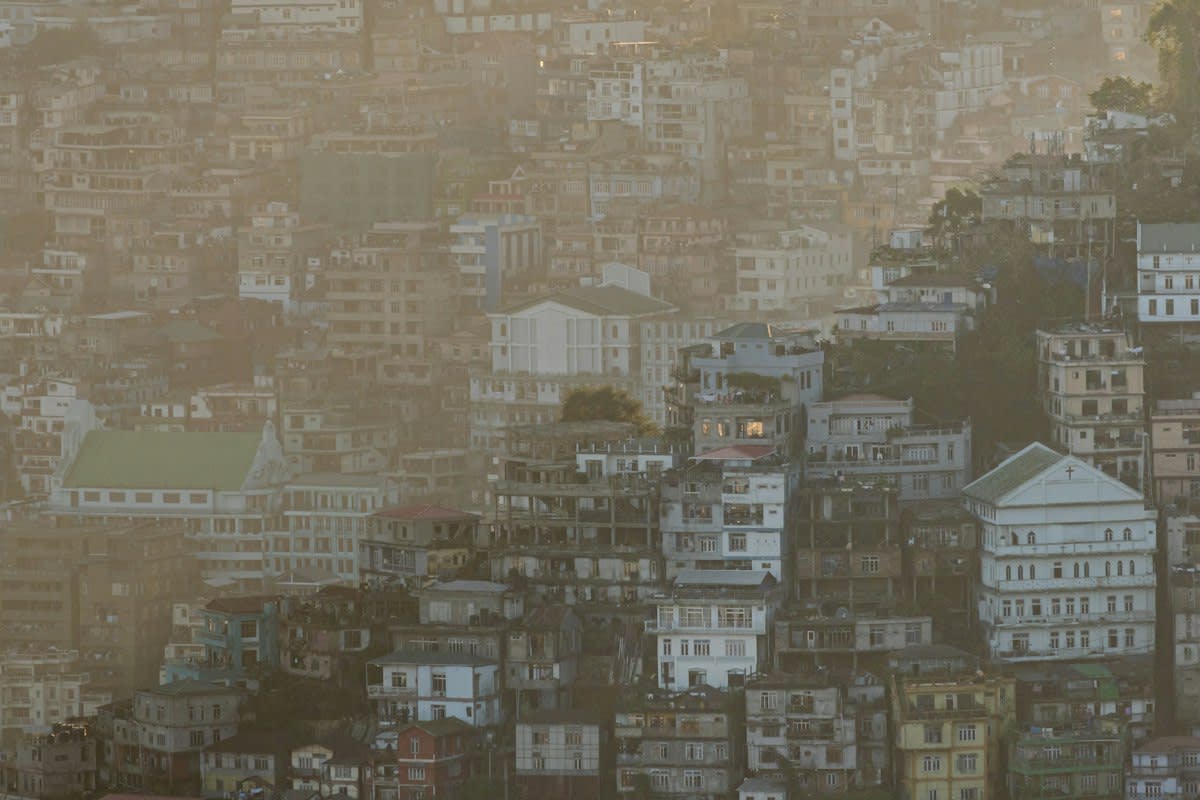 Street art being painted over in a dense urban environment