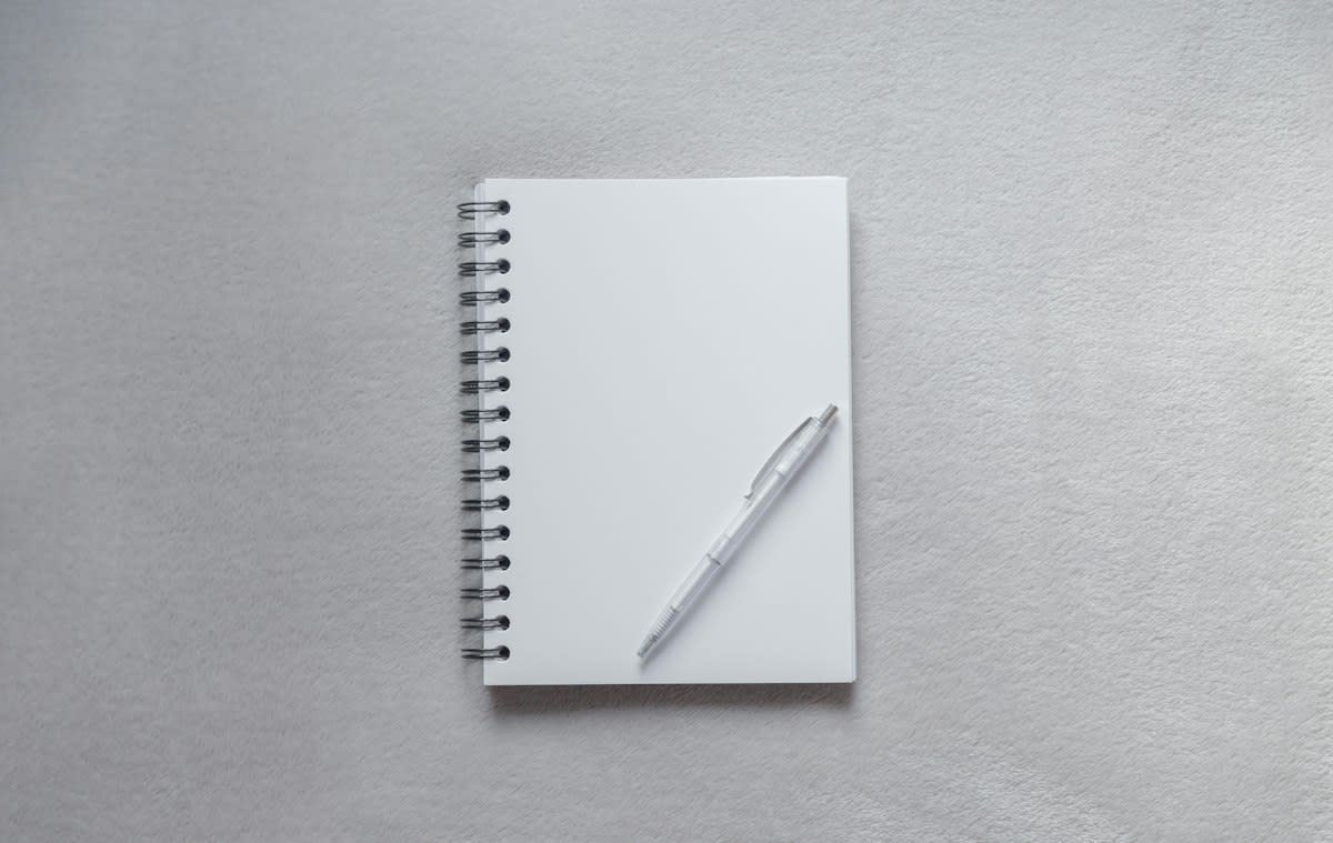 Clean workspace with a single notebook and pen