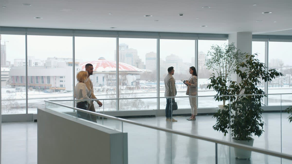 Modern corporate office corridor with blurred figures