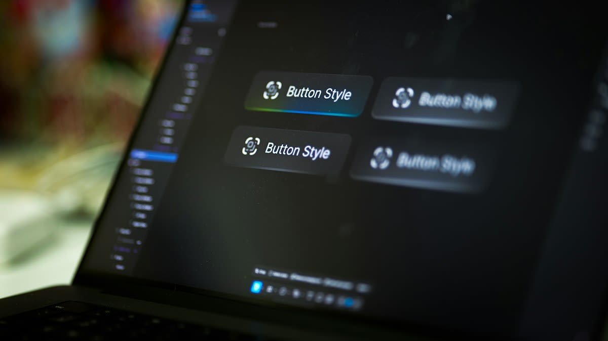 Close up of a modern computer monitor showing a complex UI design system in Figma