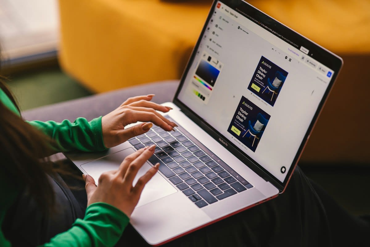 A person working on a laptop with multiple browser tabs and design tools open