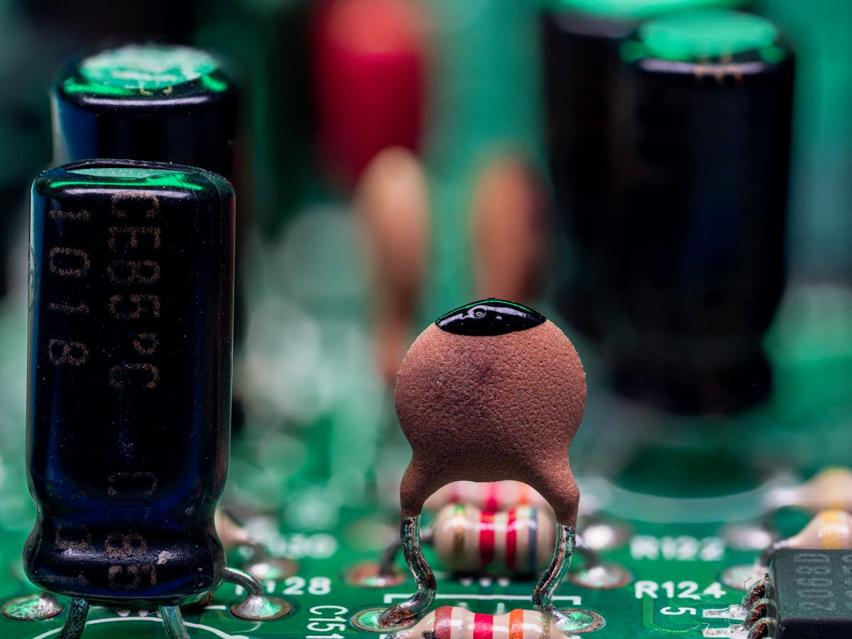 Close up of a circuit board and a zen stone