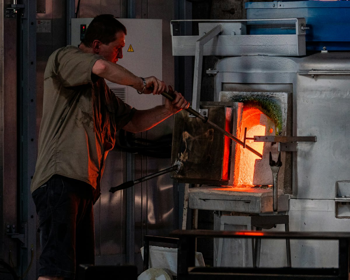 Glassblower working at a furnace