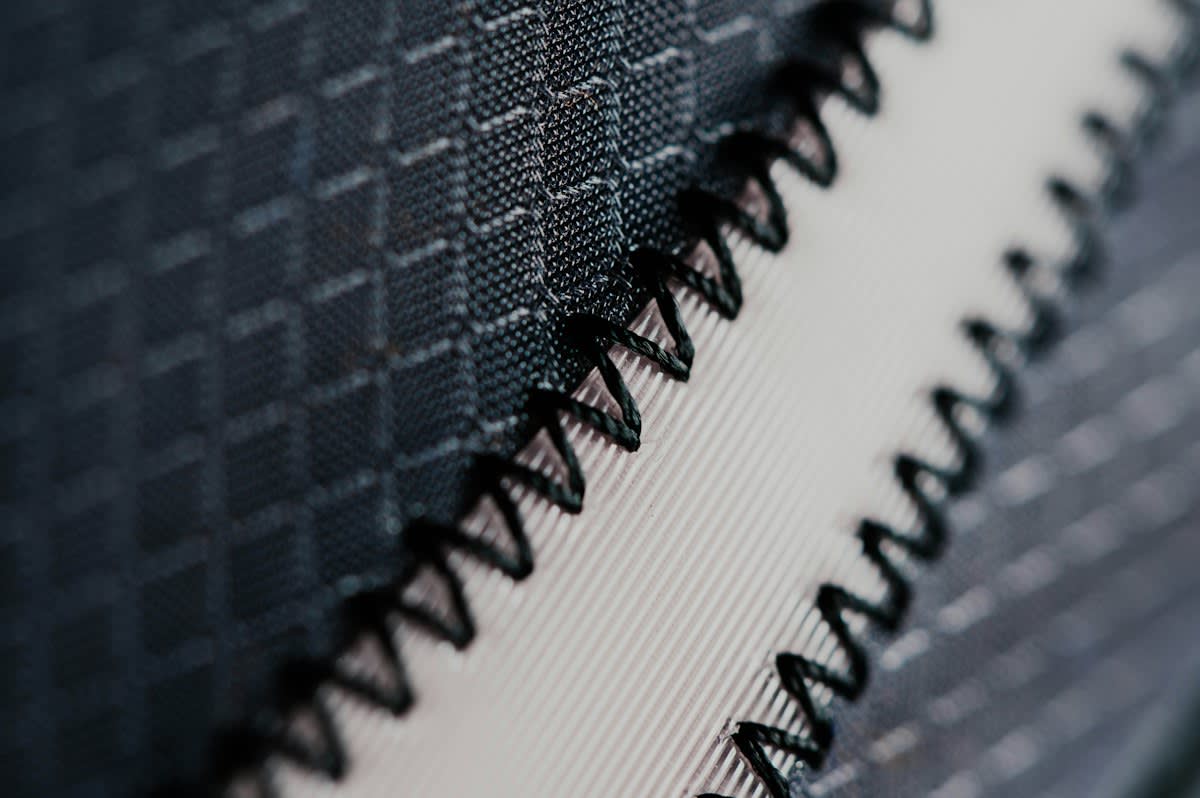 Close up of synthetic fabric fraying with plastic threads